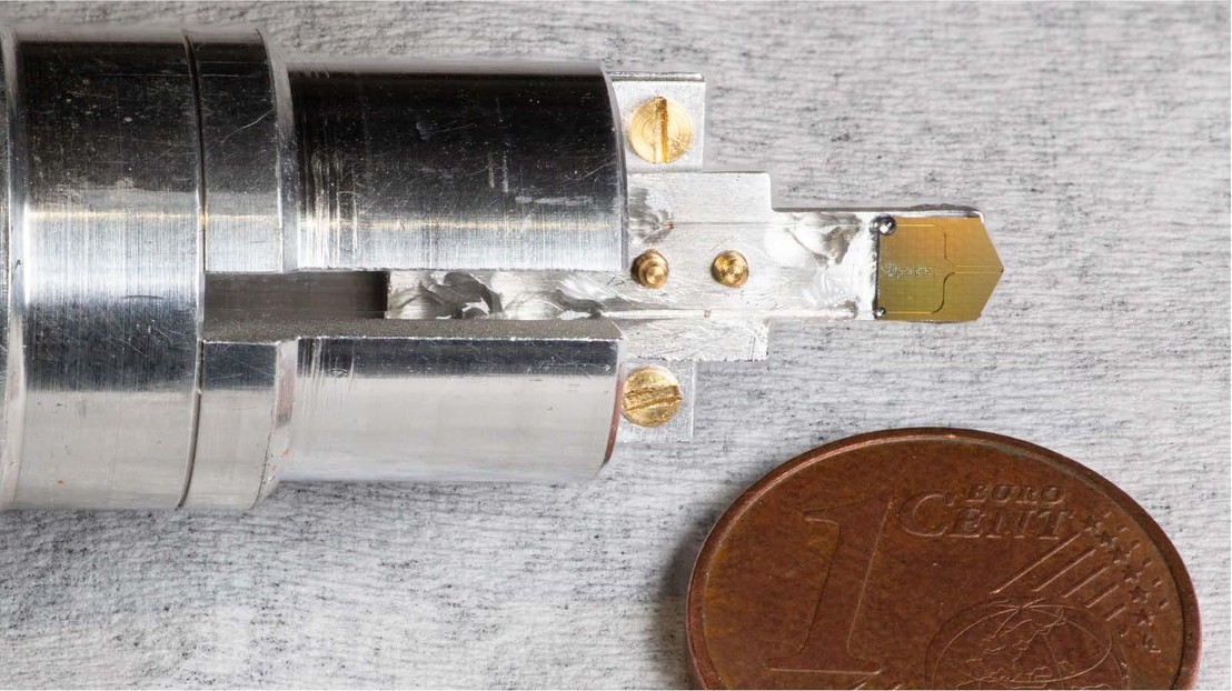 Photograph of the photonic chip mounted on a custom holder. Credit: Yang et al 2025.