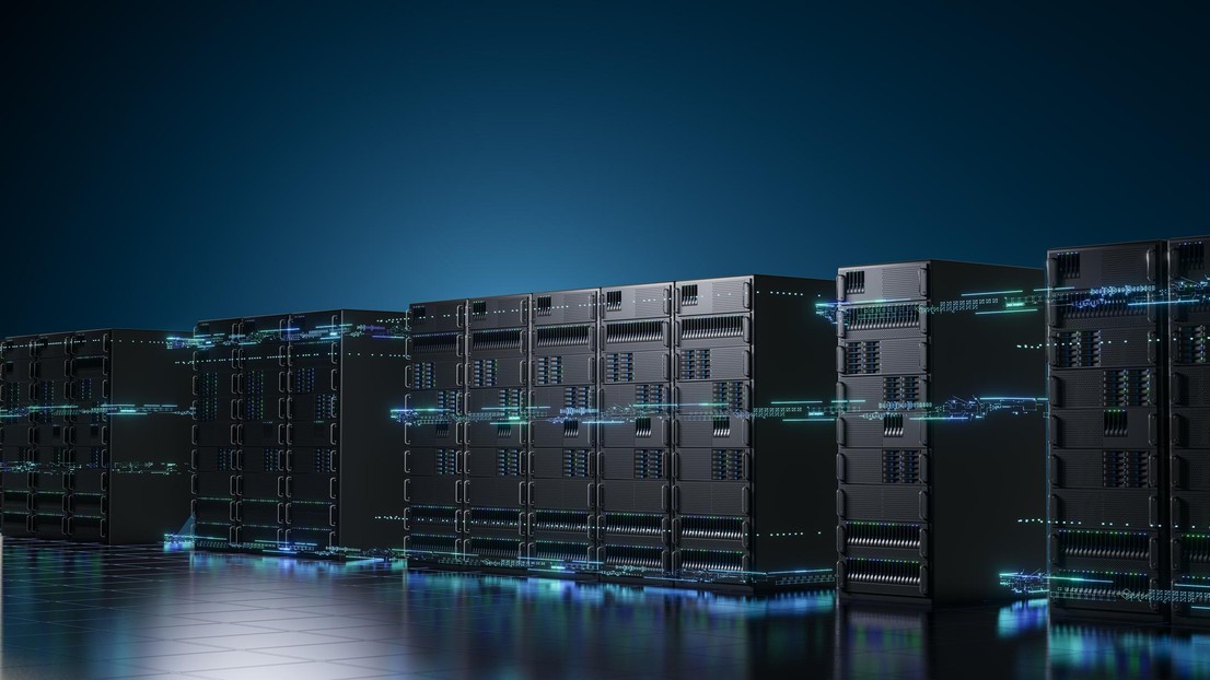 Row of modern server racks in a data center illuminated by blue lights © iStock