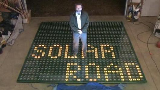 Solar roadways inventor Brusaw stands on a prototype